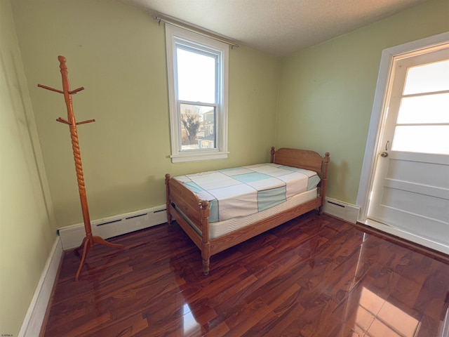 118 N Portland Ave, Ventnor, NJ 08406 - bedroom featuring wood finished floors, a baseboard radiator, a textured ceiling, and baseboards