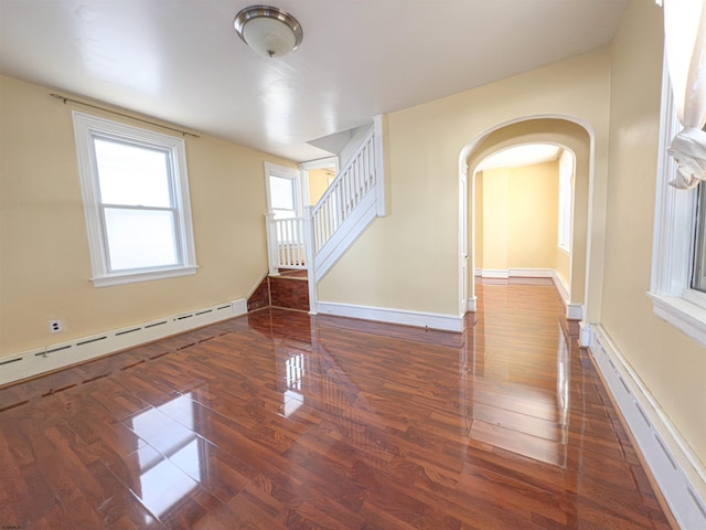 118 N Portland Ave, Ventnor, NJ 08406 - empty room featuring baseboard heating, wood finished floors, arched walkways, and baseboards