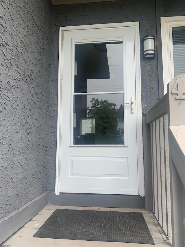 doorway to property with stucco siding