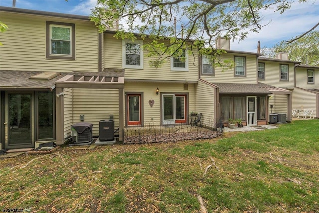 669 E Lake Front Cir Unit 669, Smithville, NJ 08205 - back of house featuring a chimney, central AC, a lawn, and a shingled roof