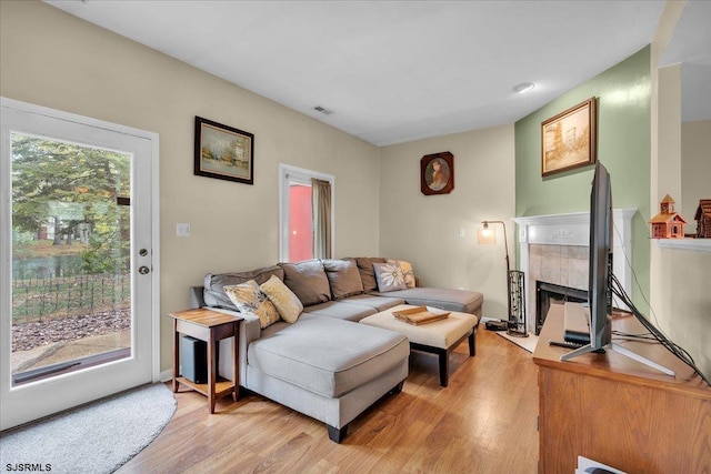 669 E Lake Front Cir Unit 669, Smithville, NJ 08205 - living room featuring light wood-style floors and a tiled fireplace
