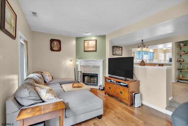 669 E Lake Front Cir Unit 669, Smithville, NJ 08205 - living room featuring light wood-style floors and a tile fireplace