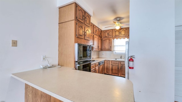 711 N Ohio Ave, Atlantic City, NJ 08401 - kitchen with ceiling fan, light countertops, a sink, a peninsula, and dishwasher