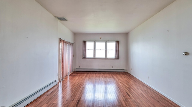 711 N Ohio Ave, Atlantic City, NJ 08401 - unfurnished room with a baseboard radiator, hardwood / wood-style floors, and baseboards