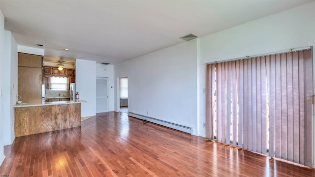 711 N Ohio Ave, Atlantic City, NJ 08401 - unfurnished living room with a baseboard radiator and wood finished floors