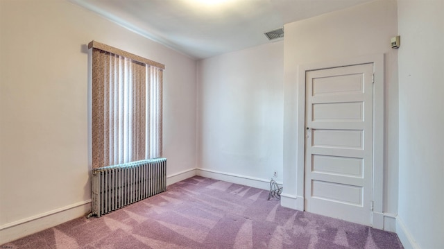 711 N Ohio Ave, Atlantic City, NJ 08401 - carpeted empty room featuring radiator and baseboards