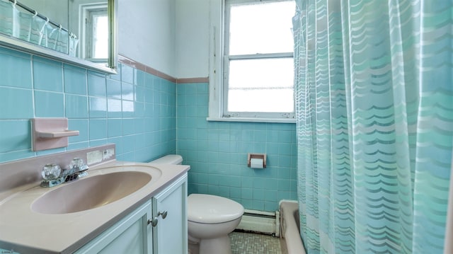 711 N Ohio Ave, Atlantic City, NJ 08401 - bathroom featuring plenty of natural light, tile walls, toilet, baseboard heating, and vanity
