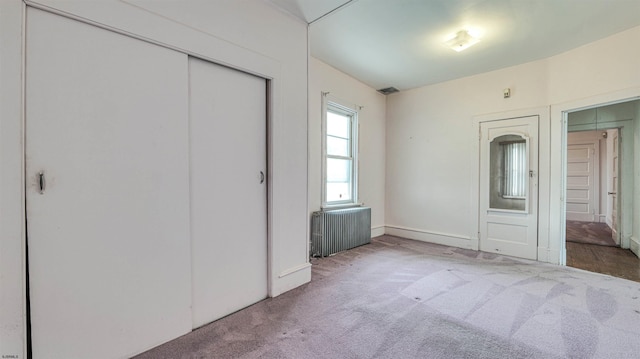 711 N Ohio Ave, Atlantic City, NJ 08401 - unfurnished bedroom with radiator, carpet flooring, a closet, and baseboards