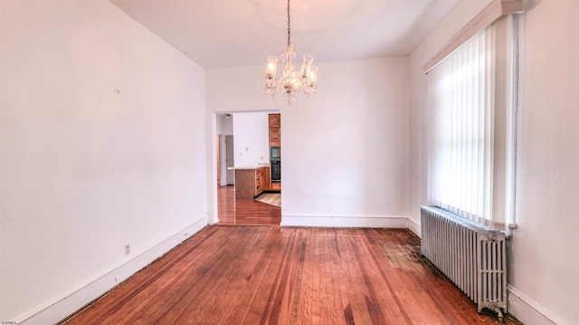711 N Ohio Ave, Atlantic City, NJ 08401 - unfurnished dining area featuring radiator heating unit, a chandelier, wood-type flooring, and baseboards