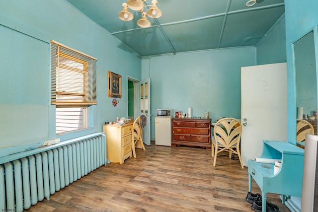 32 N Florida Ave, Atlantic City, NJ 08401 - miscellaneous room with radiator heating unit, wood finished floors, and a chandelier