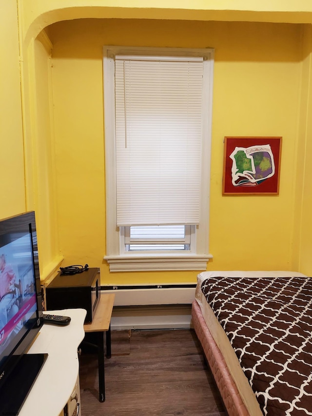 32 N Florida Ave, Atlantic City, NJ 08401 - bedroom featuring dark wood finished floors, arched walkways, and a baseboard radiator
