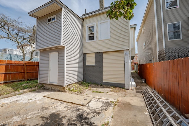 32 N Florida Ave, Atlantic City, NJ 08401 - rear view of property featuring a patio area, a fenced backyard, and brick siding