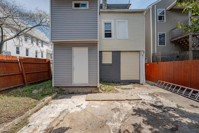 32 N Florida Ave, Atlantic City, NJ 08401 - rear view of house featuring a fenced backyard, a patio area, and brick siding