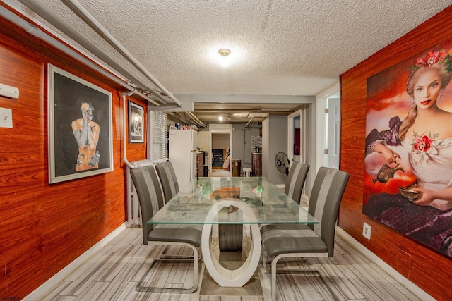 32 N Florida Ave, Atlantic City, NJ 08401 - dining area with wood walls, a textured ceiling, and baseboards