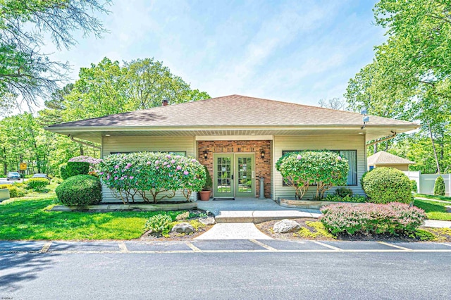 277 Mattix Run Unit 277, Galloway Township, NJ 08205 - view of front of house featuring french doors, a shingled roof, brick siding, and a chimney