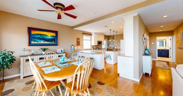 dining space with light wood finished floors, ceiling fan, recessed lighting, and baseboards