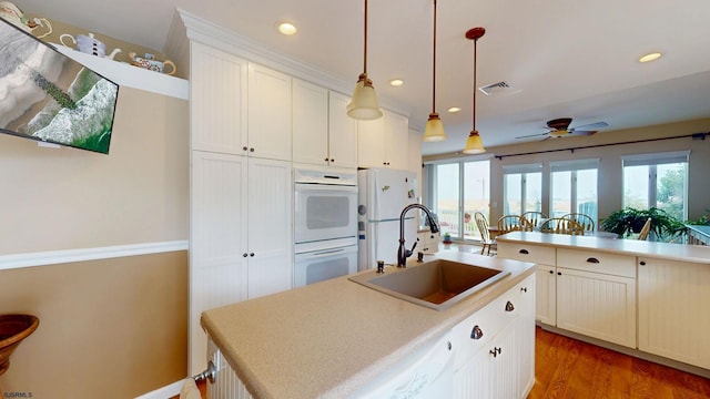 kitchen featuring a sink, white appliances, a ceiling fan, plenty of natural light, and recessed lighting