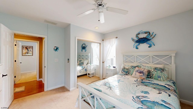 bedroom featuring a closet, carpet flooring, baseboards, and ceiling fan