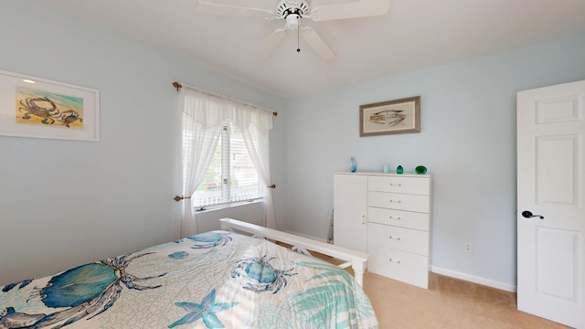 bedroom featuring light colored carpet, baseboards, and ceiling fan