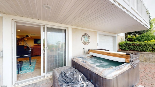 view of patio / terrace with a hot tub