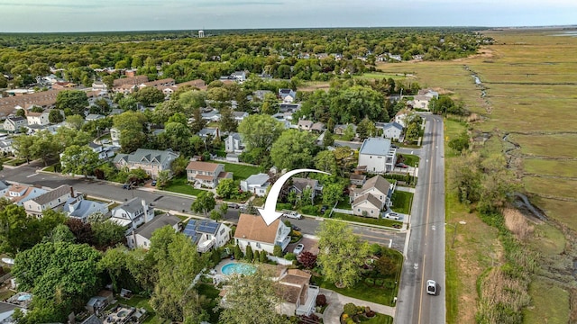 aerial view of property and surrounding area featuring nearby suburban area