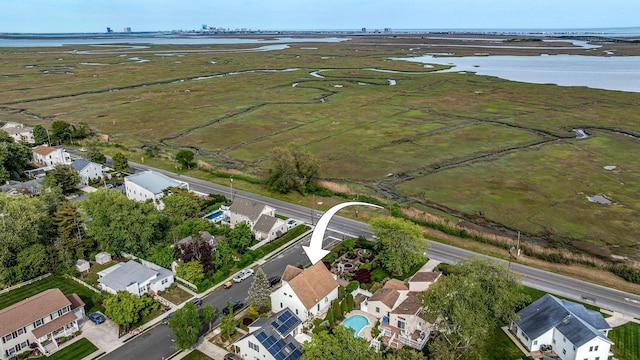 aerial overview of property's location with a large body of water and nearby suburban area