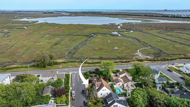 view of property location with a large body of water and nearby suburban area