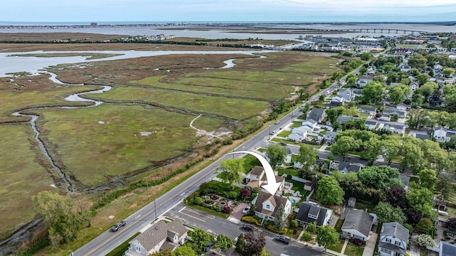 aerial view of property's location featuring a large body of water and nearby suburban area