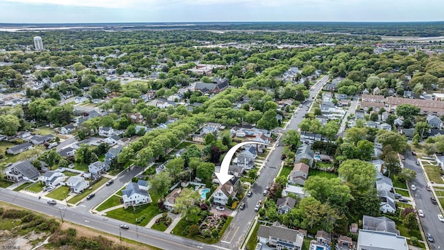 aerial view of property and surrounding area featuring nearby suburban area
