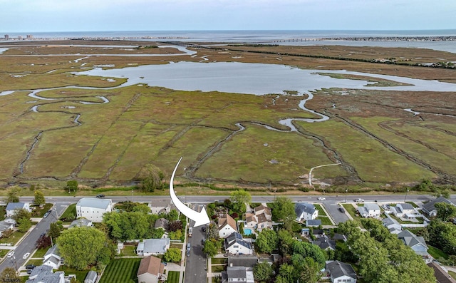 view of property location featuring a nearby body of water and nearby suburban area