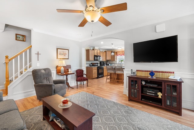 2058 Rte 9, Ocean View, NJ 08230 - living room with a ceiling fan, light wood-style flooring, stairway, crown molding, and wainscoting