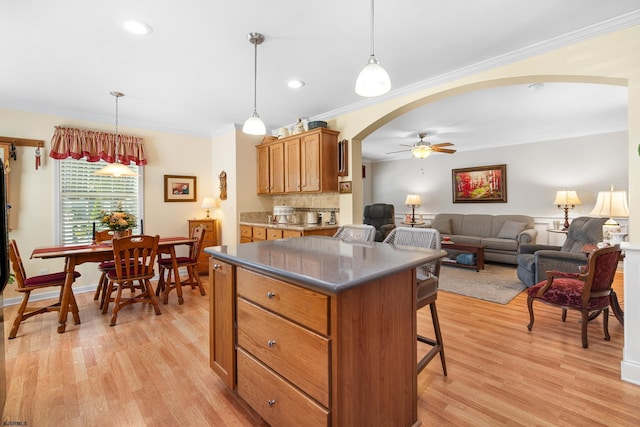 2058 Rte 9, Ocean View, NJ 08230 - kitchen featuring arched walkways, ceiling fan, light wood-type flooring, brown cabinetry, and crown molding