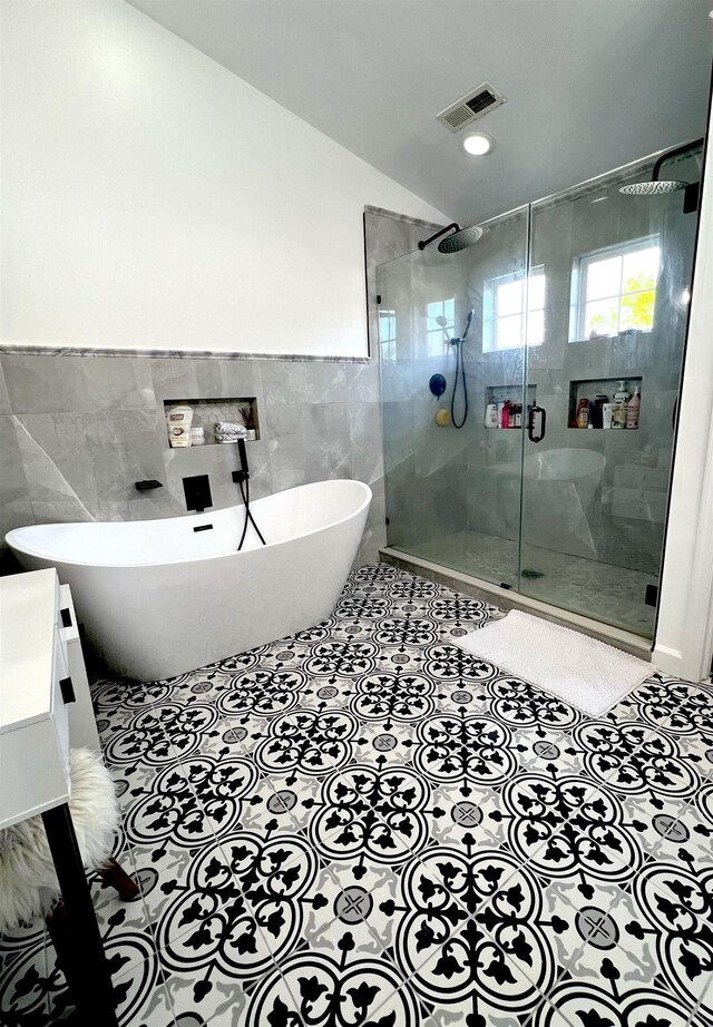 11 Gallant Fox Ln, Egg Harbor Township, NJ 08234 - bathroom featuring tile walls, a freestanding tub, a stall shower, wainscoting, and tile patterned flooring