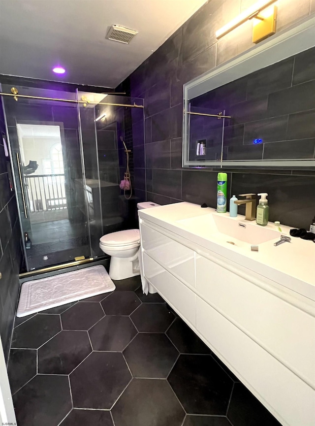11 Gallant Fox Ln, Egg Harbor Township, NJ 08234 - bathroom with tile walls, toilet, vanity, a shower stall, and tile patterned floors