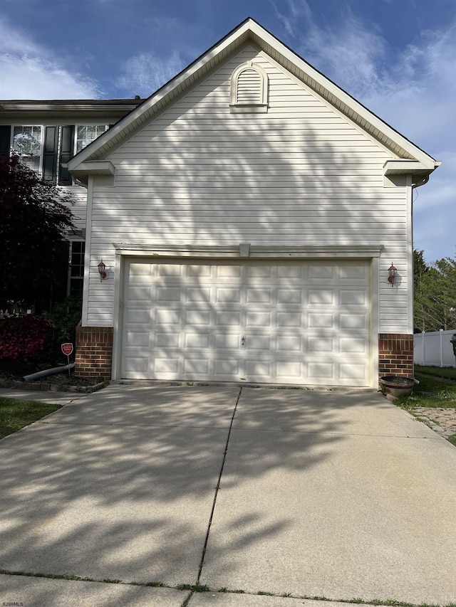 11 Gallant Fox Ln, Egg Harbor Township, NJ 08234 - view of side of property featuring driveway, brick siding, and a garage