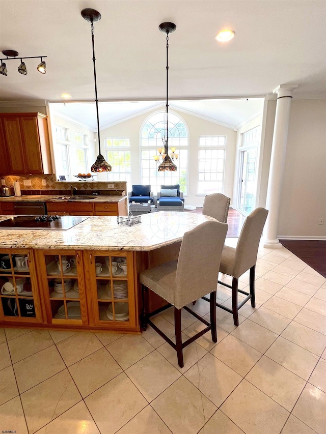 11 Gallant Fox Ln, Egg Harbor Township, NJ 08234 - kitchen with brown cabinetry, a sink, crown molding, healthy amount of natural light, and decorative backsplash