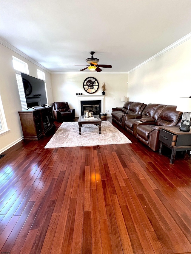 11 Gallant Fox Ln, Egg Harbor Township, NJ 08234 - living room featuring a glass covered fireplace, dark wood-style floors, a ceiling fan, ornamental molding, and baseboards