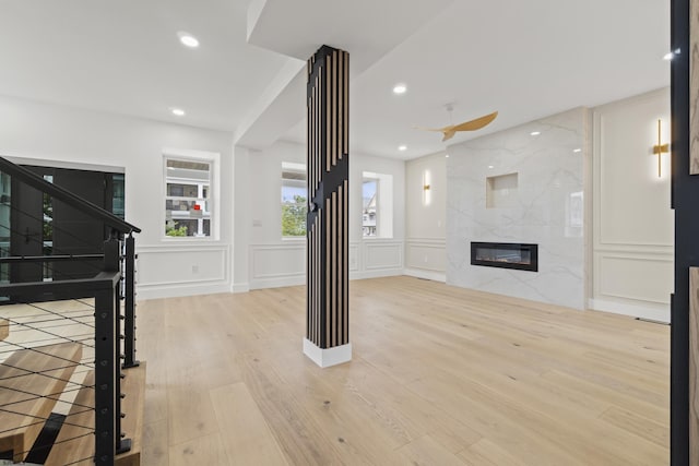 101 S Baton Rouge Ave, Ventnor, NJ 08406 - unfurnished living room featuring a decorative wall, wood finished floors, a high end fireplace, recessed lighting, and stairway