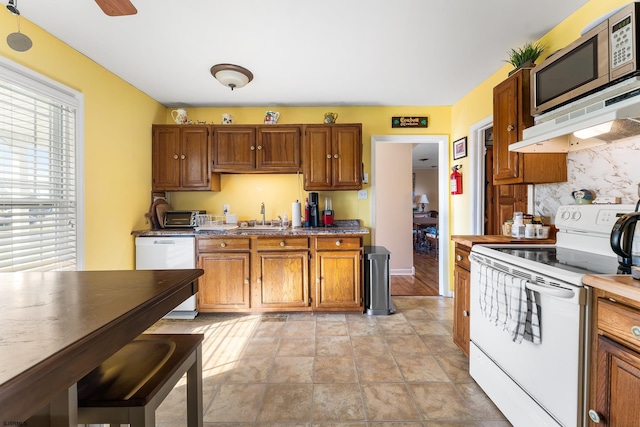 4400 Harbor Beach Blvd, Brigantine, NJ 08203 - kitchen featuring white appliances, a sink, tasteful backsplash, and brown cabinetry