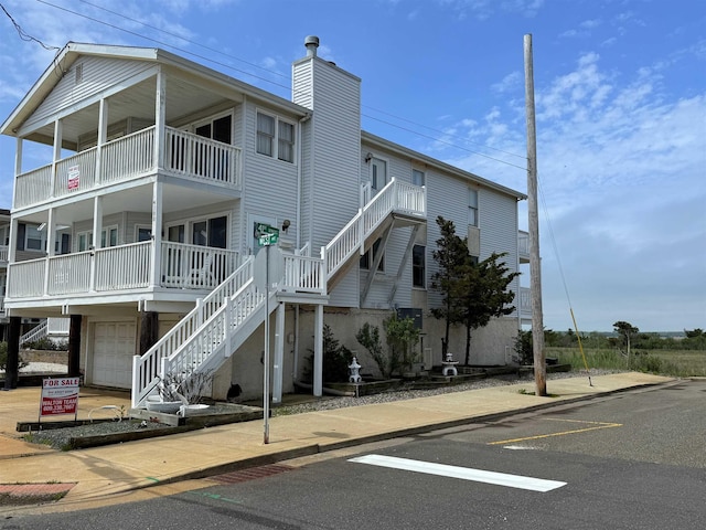 4102 W Ave Unit 2, Ocean City, NJ 08226 - view of property featuring stairs, uncovered parking, and a garage