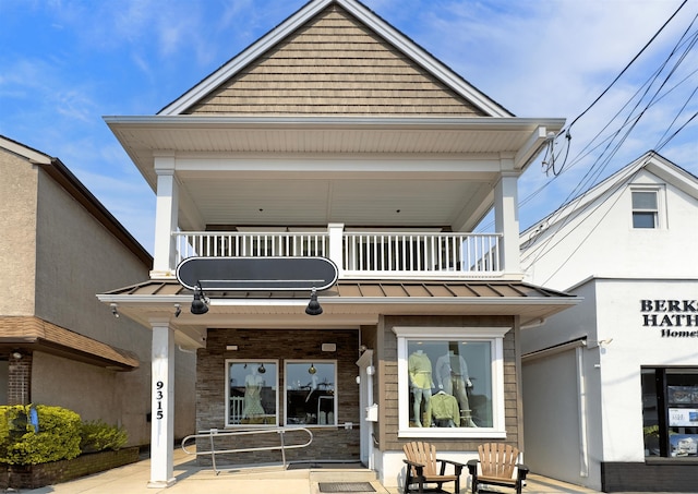 9315 Ventnor Ave, Margate, NJ 08402 - view of front of property with a balcony, a standing seam roof, metal roof, and covered porch