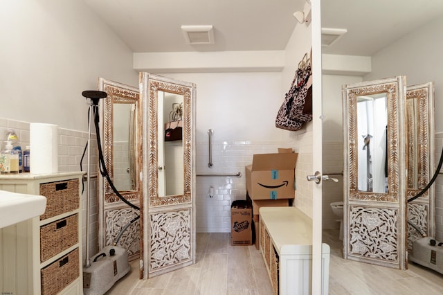 9315 Ventnor Ave, Margate, NJ 08402 - bathroom with tile walls, toilet, and wainscoting