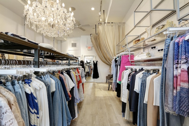 9315 Ventnor Ave, Margate, NJ 08402 - spacious closet with light wood-type flooring, a chandelier, and a ceiling fan