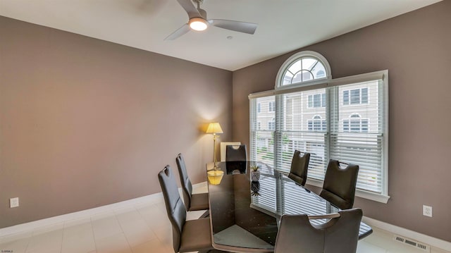 dining space with a ceiling fan, baseboards, and a desk