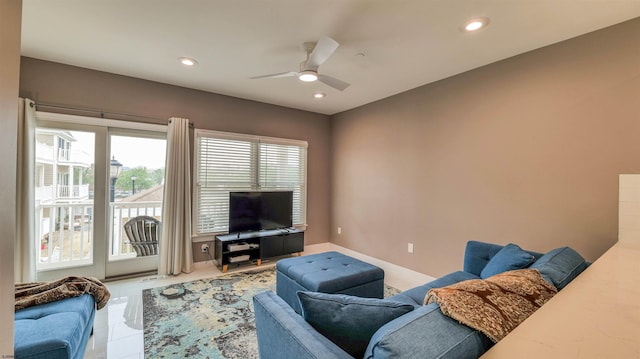 living room with a ceiling fan, healthy amount of natural light, recessed lighting, tile patterned floors, and baseboards