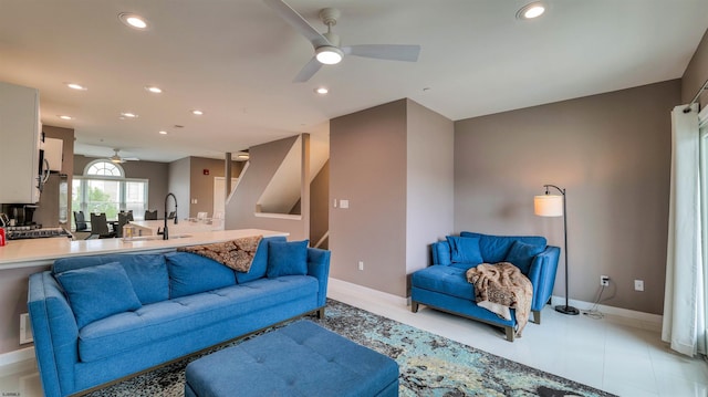 living room with ceiling fan, recessed lighting, baseboards, and stairway