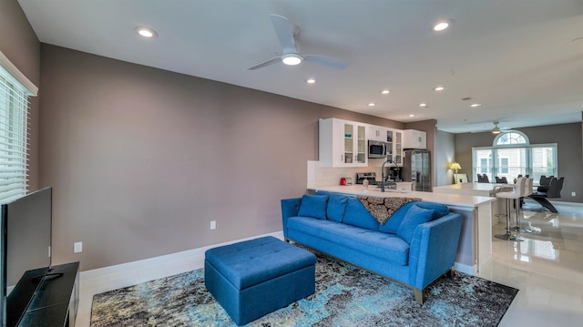 living room with a ceiling fan, recessed lighting, light tile patterned flooring, and baseboards