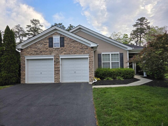 317 Southmoor Dr, Galloway Township, NJ 08205 - view of front of house with driveway, stone siding, an attached garage, and a front yard