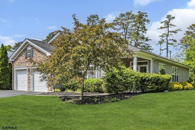 317 Southmoor Dr, Galloway Township, NJ 08205 - view of property exterior with asphalt driveway, a yard, and stone siding