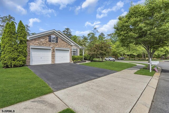 317 Southmoor Dr, Galloway Township, NJ 08205 - view of front of house featuring stone siding, asphalt driveway, a front yard, and a garage
